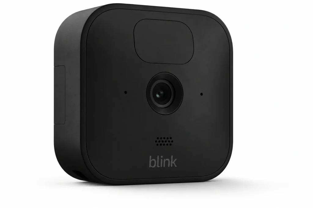 The Blink Outdoor 4, a small black-and-white square battery camera, mounted on an exterior wall.